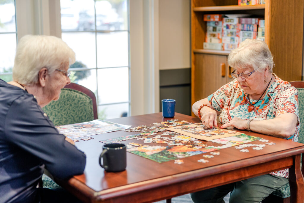 Two Residents Doing a Puzzle Together | Pelican Valley Senior Living
