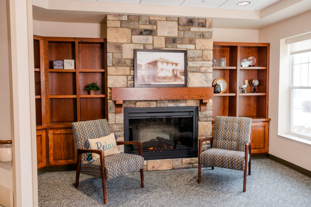 Chairs Next to Fireplace | Pelican Valley Senior Living