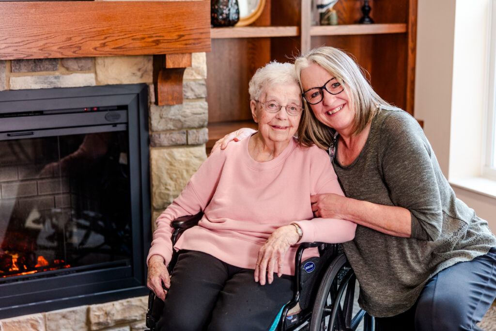 A Team Member with Her Arm Around a Resident, Smiling | Pelican Valley Senior Living