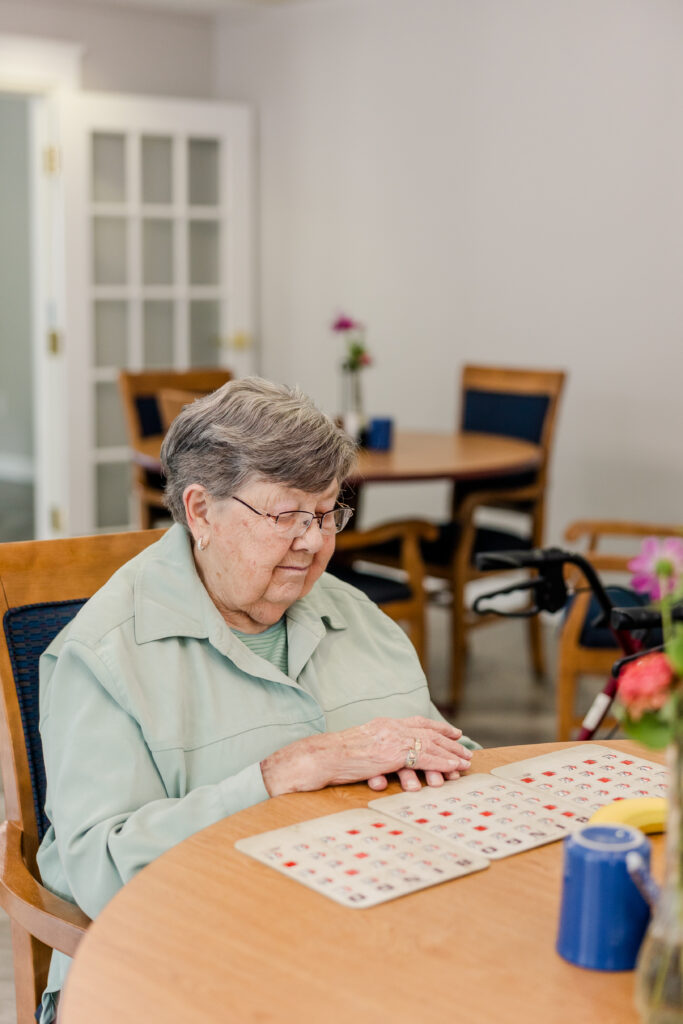 Resident Playing Bingo | Pelican Valley Senior Living