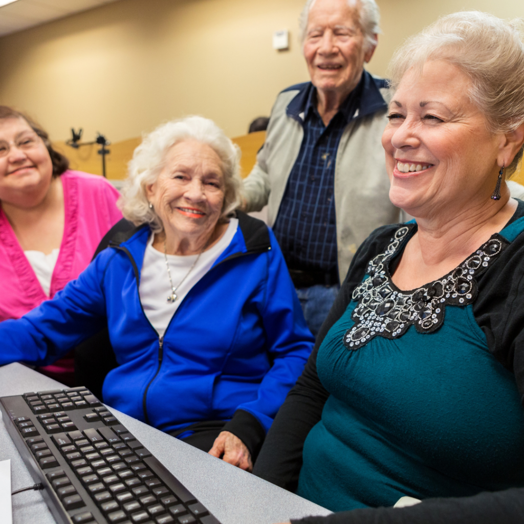 Residents on the Computer Together | Pelican Valley Senior Living
