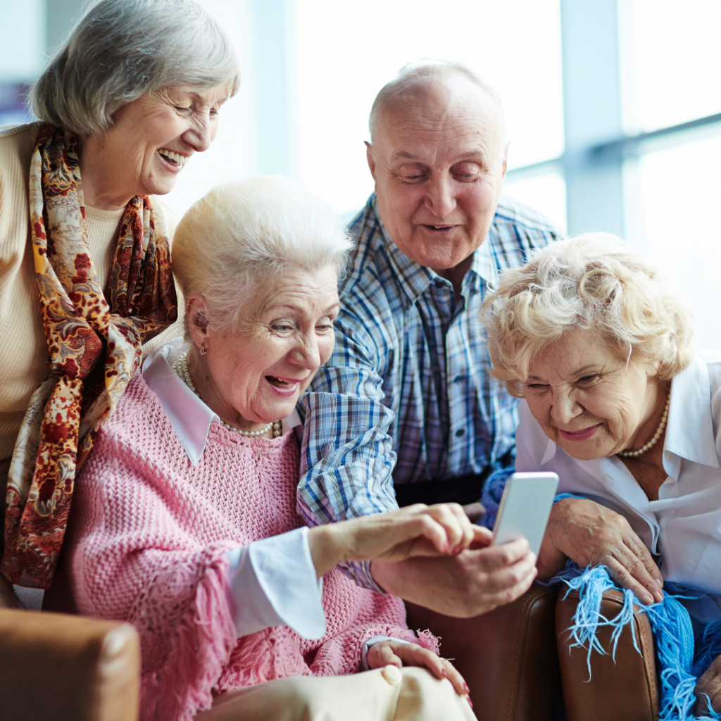 Residents Looking at Phone Together | Pelican Valley Senior Living