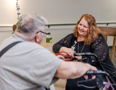 Team Member Smiling at a Resident | Pelican Valley Senior Living